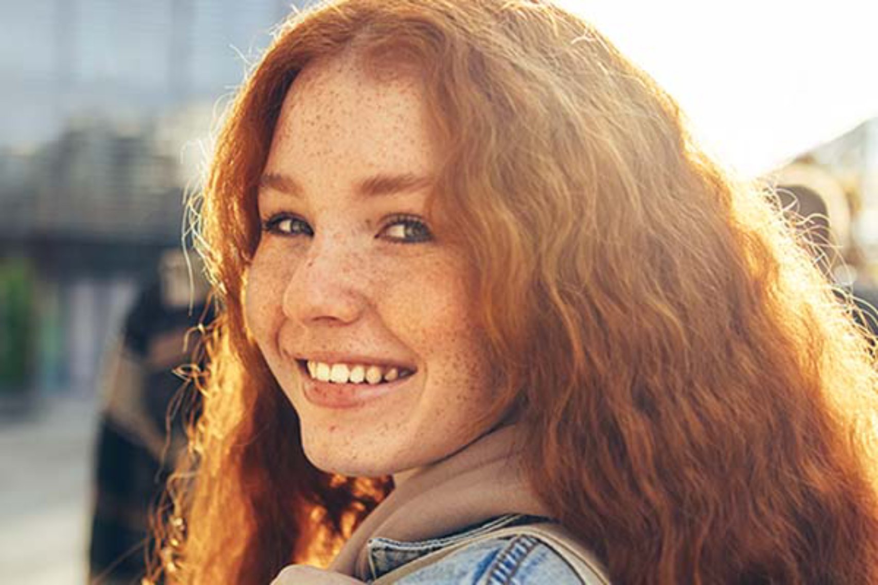 Smiling curly hair woman looking back at camera